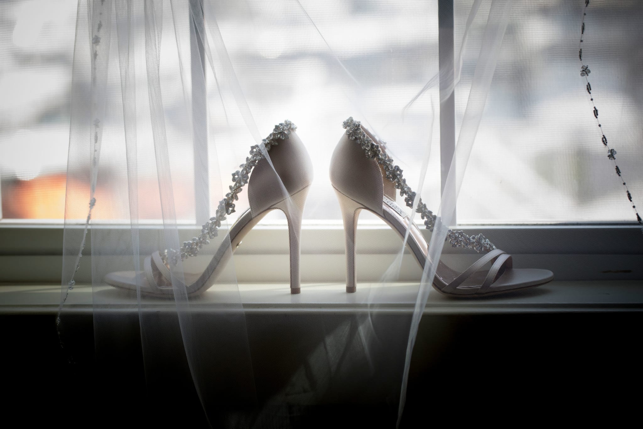 Jessica's wedding shoes on a windowsill.