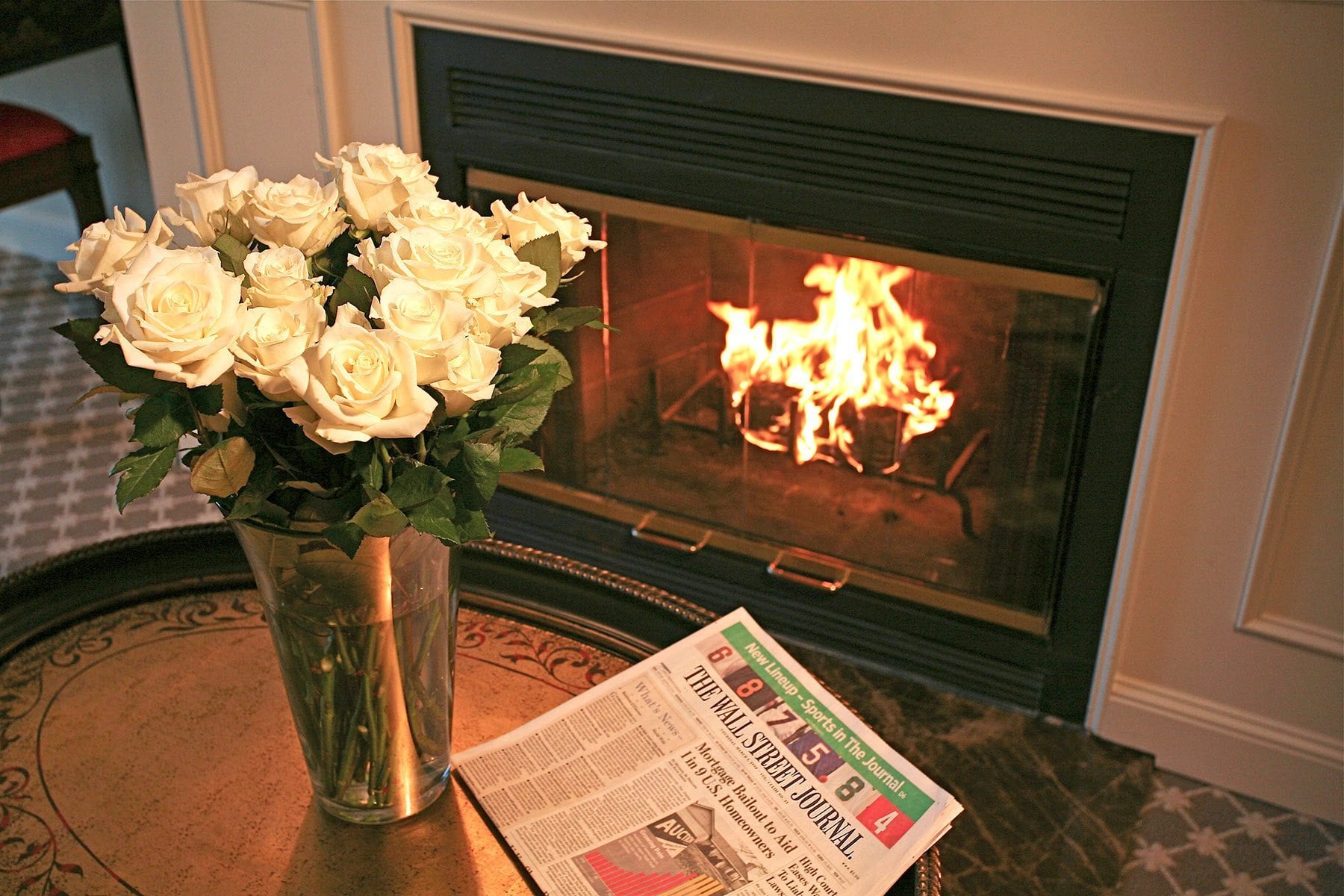 Flowers near fireplace.