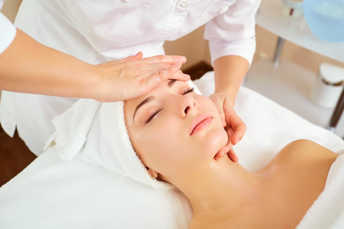 Woman at a facial massage at a spa salon.