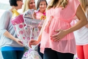 Pregnant woman celebrating baby shower party with friends