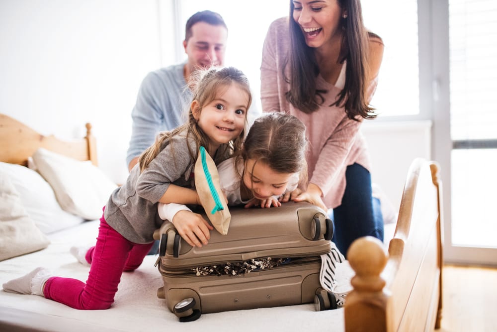 Photo of a Family Packing. Click Here to Learn How to Travel with Kids