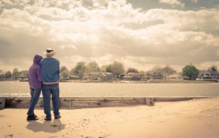 An older couple stand on the beach in Old Saybrook, CT, which is full of history.