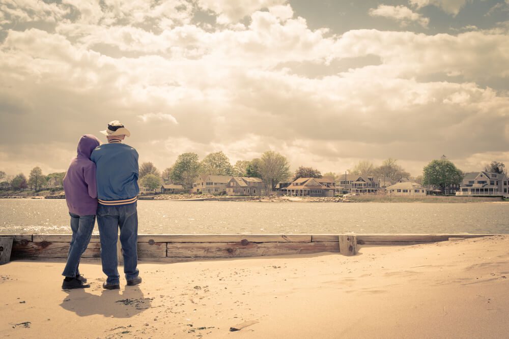 An older couple stand on the beach in Old Saybrook, CT, which is full of history.