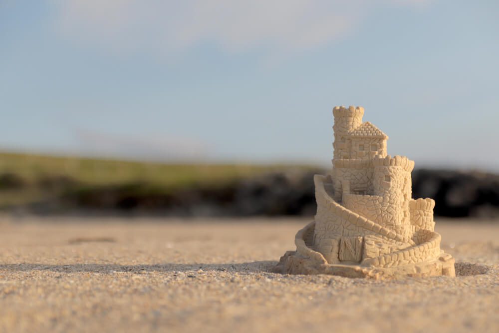 A sandcastle sits on the serene shores of Harvey's Beach.